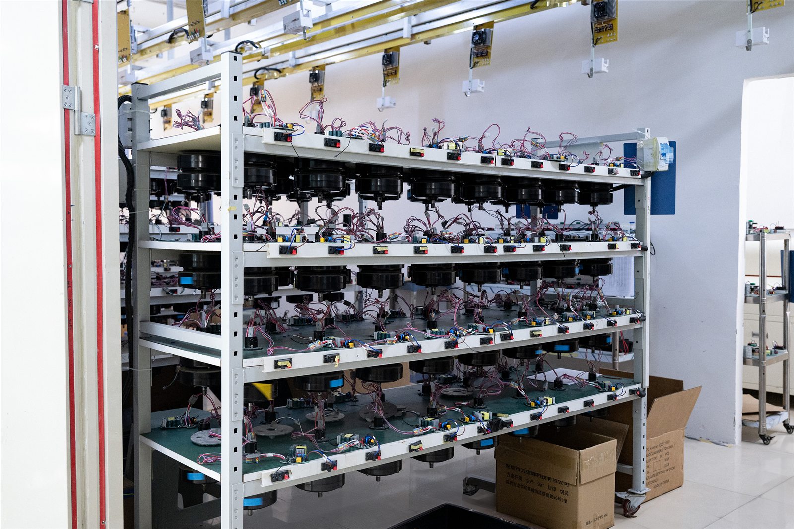 Racks of powered assemblies undergoing burn-in aging test