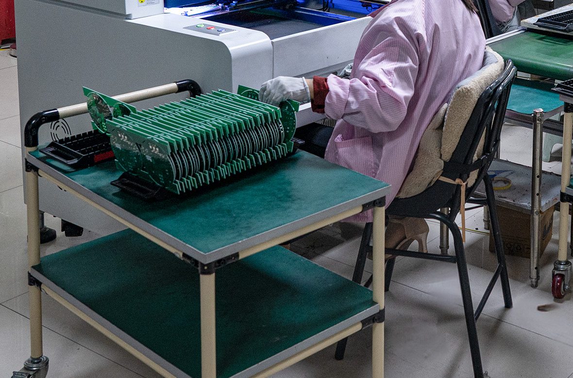 Racks of finished PCB assemblies coming off the GMIC line